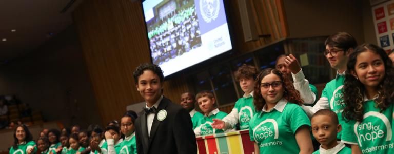 Children from 'Sing for Hope' perform a song during the closing of HLPF 2023, played on the SDG piano