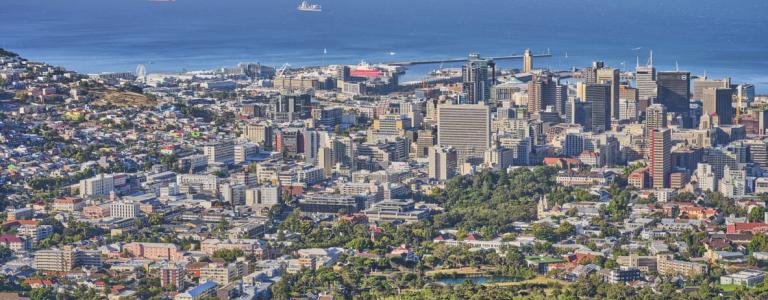 Cape Town coastline with building in the foreground and a bay in the background