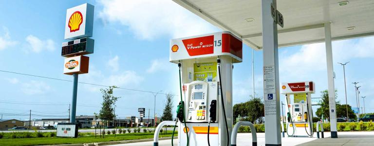 A shell gas station with no cars at the pumps.