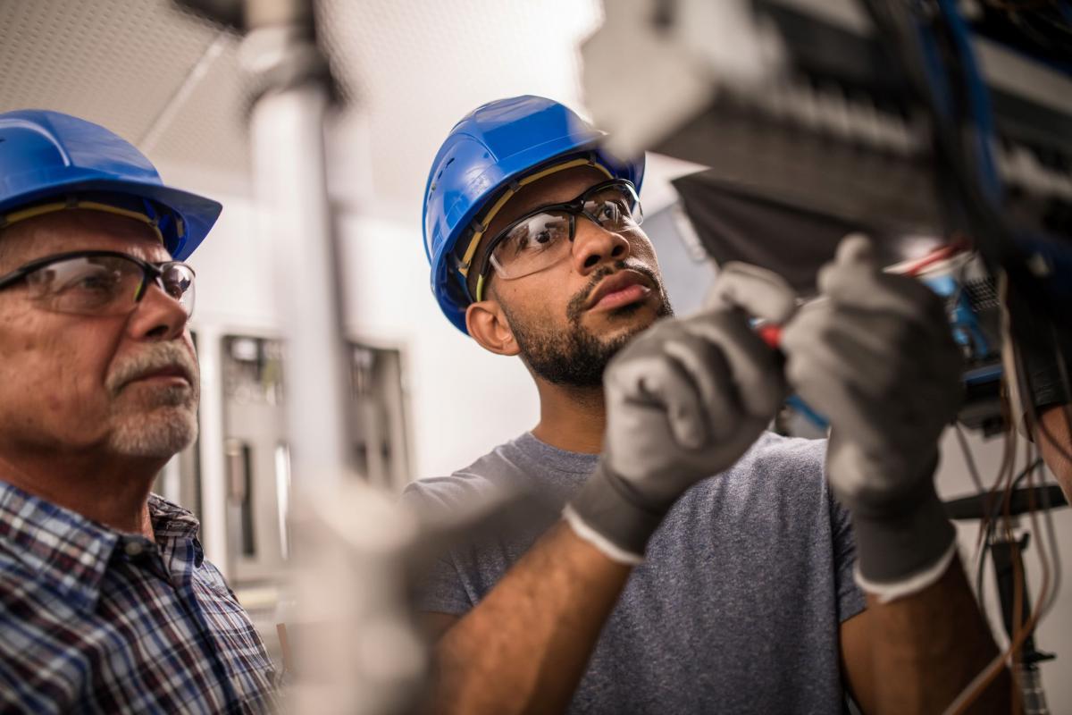 The Revolution Will Be Retrofitted The Future Of Energy Efficiency In   Electricians Working On Fuse Box 