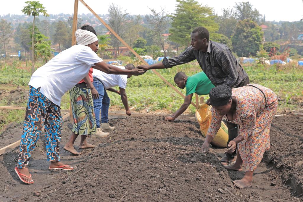 SUNCASA | Women and men from ARCOS Network planting seedlings in a project nursery in Kigali. (Photo: William Bidibura | ARCOS Network | SUNCASA)