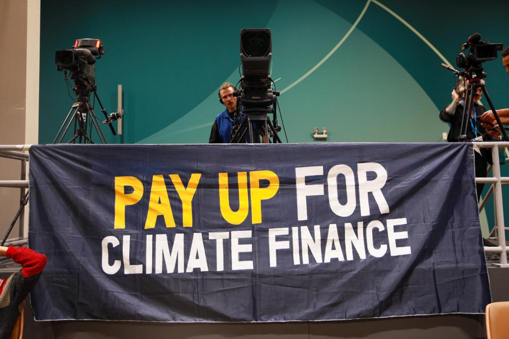 A banner at COP 29 reading: "PAY UP FOR CLIMATE FINANCE"