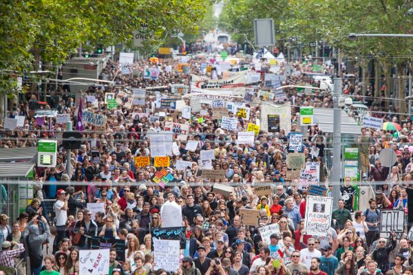 Thousands of peeople marching for climate justice in Australia, bird's eye view