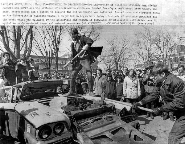 Students at the University of Michigan smash a car at the first Earth Day event in 1970